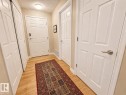 Inviting entryway featuring light wood-finish flooring, multiple paneled doors, and a flush mount ceiling light - 301 9803 96A Street, Edmonton, AB  - Indoor Photo Showing Other Room 