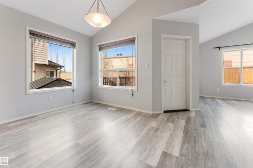 Open concept interior with light wood-finish flooring - 123 Rue Masson, Beaumont, AB - Indoor Photo Showing Other Room