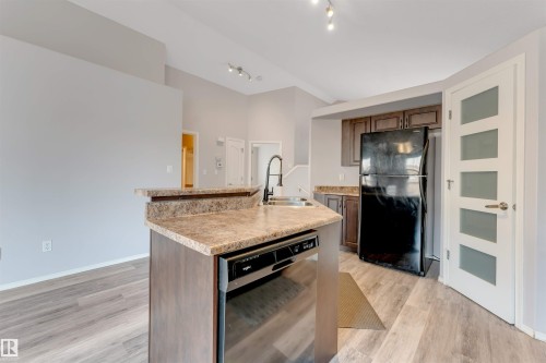 Open-concept living space with light wood-finish flooring - 123 Rue Masson, Beaumont, AB - Indoor Photo Showing Kitchen