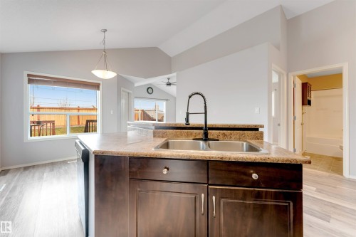 Open-concept kitchen and dining area featuring light wood-finish flooring - 123 Rue Masson, Beaumont, AB - Indoor Photo Showing Kitchen
