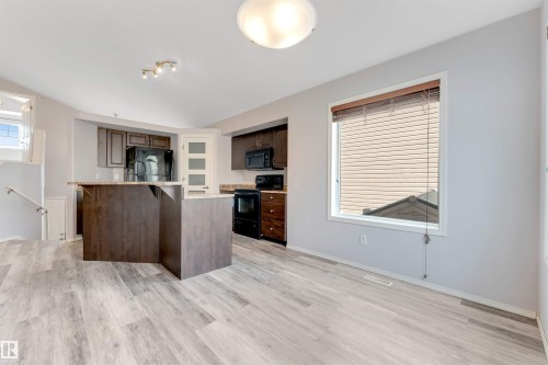 Carpeted room featuring a double bifold closet, an interior door, and light gray wall paint - 123 Rue Masson, Beaumont, AB - Indoor Photo Showing Other Room