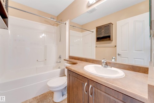 Neutral-toned carpeting paired with light gray walls and white trim - 123 Rue Masson, Beaumont, AB - Indoor Photo Showing Other Room