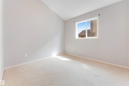 Open-concept living space with vaulted ceilings, wood-finish flooring, and a ceiling fan - 123 Rue Masson, Beaumont, AB - Indoor Photo Showing Other Room