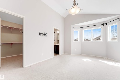 Vaulted ceiling room with neutral carpeting and light gray walls - 123 Rue Masson, Beaumont, AB - Indoor Photo Showing Other Room