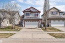 Two-story residential property featuring light gray siding and red trim accents - 123 Rue Masson, Beaumont, AB  - Outdoor With Facade 