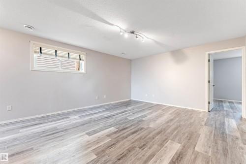Expansive backyard featuring a large grass area, wood privacy fencing, and a multi-level wood deck with stairs - 123 Rue Masson, Beaumont, AB - Outdoor