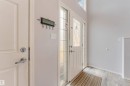 Entryway featuring a white paneled door with decorative glass inserts, a frosted glass sidelight, and a transom window - 123 Rue Masson, Beaumont, AB  - Indoor Photo Showing Other Room 