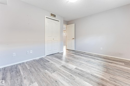 Aerial perspective showcasing a residential neighborhood with a dense arrangement of single-family homes and townhouses - 123 Rue Masson, Beaumont, AB - Outdoor With View