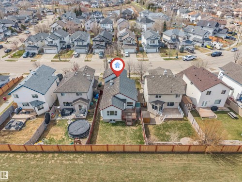 Aerial view of a residential neighborhood featuring multiple single-family homes with pitched roofs and attached garages - 123 Rue Masson, Beaumont, AB - Outdoor With View
