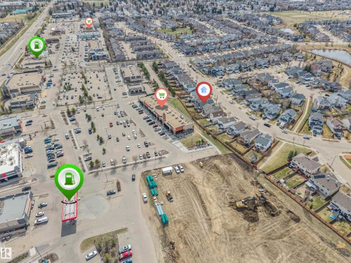 Aerial perspective showcasing residential properties within a developed neighborhood - 123 Rue Masson, Beaumont, AB - 