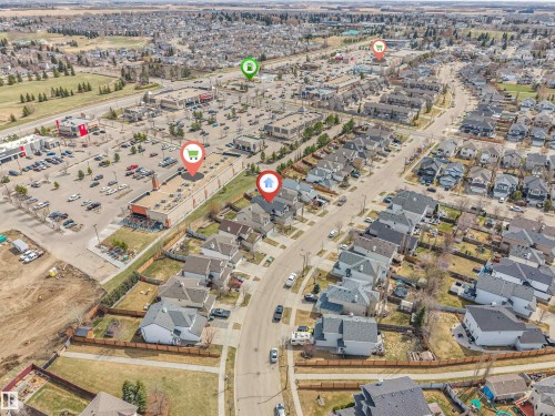 Aerial perspective showcasing a residential neighborhood with a dense arrangement of single-family homes and townhouses - 123 Rue Masson, Beaumont, AB - Outdoor With View
