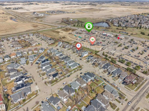 Aerial neighborhood view featuring residential properties with varying roof styles - 123 Rue Masson, Beaumont, AB - Outdoor With View