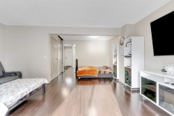 The property features dark hardwood style flooring throughout, light-colored walls, and a white ceiling - 