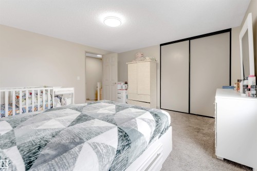 This room features light-colored walls and carpeted flooring, creating a neutral canvas - 37 1411 Mill Woods Road E, Edmonton, AB - Indoor Photo Showing Bedroom