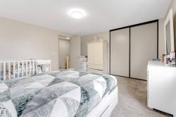 This room features light-colored walls and carpeted flooring, creating a neutral canvas - 