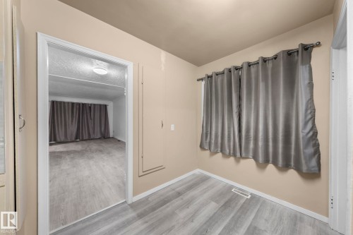 Interior space with light wood-finish flooring and neutral wall tones - 11414 85 Street, Edmonton, AB - Indoor