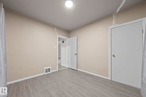 Room with light tan walls and wood-finish flooring - 11414 85 Street, Edmonton, AB - Indoor Photo Showing Other Room