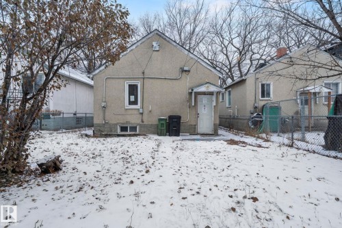 Rear exterior of a residence featuring stucco siding, a gabled roofline, and a sheltered entry - 11414 85 Street, Edmonton, AB - Outdoor