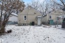 Rear exterior of a residence featuring stucco siding, a gabled roofline, and a sheltered entry - 11414 85 Street, Edmonton, AB  - Outdoor 