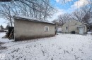 Detached auxiliary building with a single window, set on a snow-covered lot - 11414 85 Street, Edmonton, AB  - Outdoor 