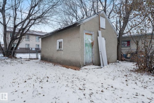Detached shed with stucco exterior, a single window with white trim, and a gabled roofline - 11414 85 Street, Edmonton, AB - Outdoor
