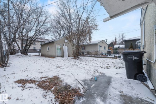 Rear yard featuring a detached shed, mature trees, and a concrete patio section - 11414 85 Street, Edmonton, AB - Outdoor