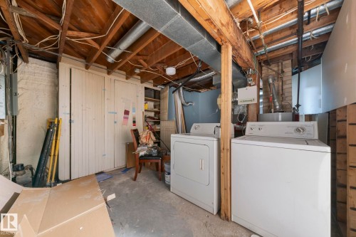 Laundry area with white appliances and exposed wood ceiling joists - 11414 85 Street, Edmonton, AB - Indoor Photo Showing Laundry Room
