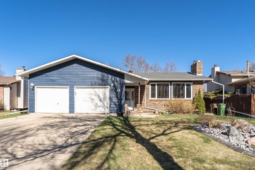 Ranch-style exterior featuring blue horizontal siding and brick accents - 49 Ash Crescent, St. Albert, AB - Outdoor