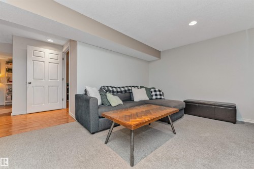 Carpeted room with recessed lighting and a white paneled door - 49 Ash Crescent, St. Albert, AB - Indoor