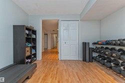 Recessed lighting illuminates wood-finish flooring - 