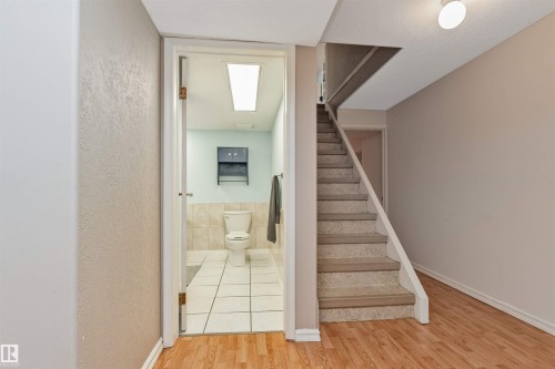 Bathroom with white floor tiling, light-colored wall tiling, and a built-in wall cabinet - 49 Ash Crescent, St. Albert, AB - Indoor Photo Showing Other Room