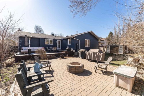 Expansive brick paver patio featuring a built-in fire pit - 49 Ash Crescent, St. Albert, AB - Outdoor With Deck Patio Veranda