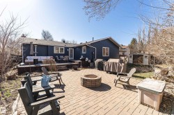 Expansive brick paver patio featuring a built-in fire pit - 