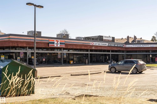 Commercial building featuring multiple storefronts with large glass windows - 49 Ash Crescent, St. Albert, AB - Outdoor