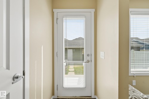 Light-filled entry with a full-view door featuring integrated blinds - 481 Sheppard Boulevard, Leduc, AB - Indoor Photo Showing Other Room