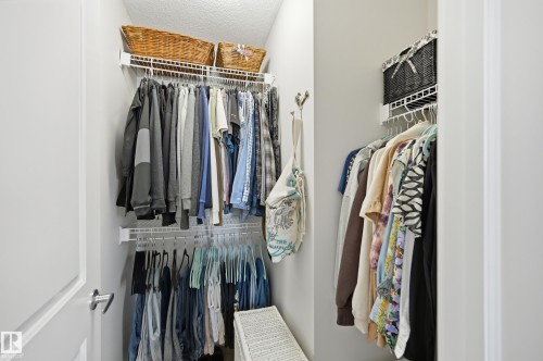Integrated closet system featuring multiple wire shelving units and hanging rods - 481 Sheppard Boulevard, Leduc, AB - Indoor With Storage
