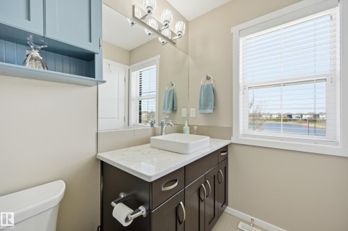 Bathroom featuring a vessel sink, dark wood-finish vanity with chrome hardware, and a light-colored countertop - 481 Sheppard Boulevard, Leduc, AB - Indoor Photo Showing Bathroom
