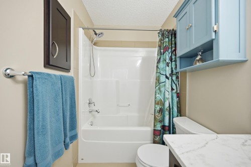 Bathtub and shower combination featuring a chrome showerhead and faucet - 481 Sheppard Boulevard, Leduc, AB - Indoor Photo Showing Bathroom
