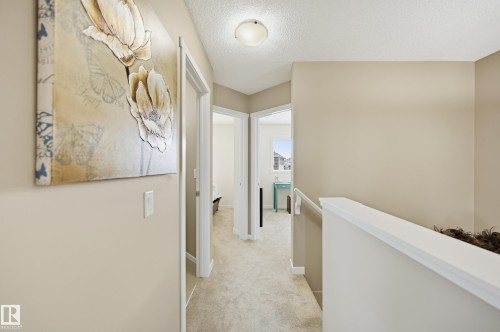 Carpeted hallway with neutral wall tones and white trim - 481 Sheppard Boulevard, Leduc, AB - Indoor Photo Showing Other Room
