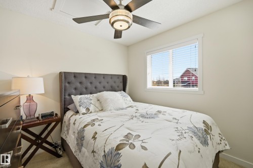 Light-filled room featuring an overhead ceiling fan with integrated lighting, a single window with horizontal blinds, and neutral-toned walls - 481 Sheppard Boulevard, Leduc, AB - Indoor Photo Showing Bedroom