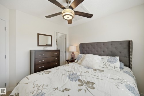 Recessed ceiling with an overhead fan featuring wood-finish blades and a drum light fixture - 481 Sheppard Boulevard, Leduc, AB - Indoor Photo Showing Bedroom