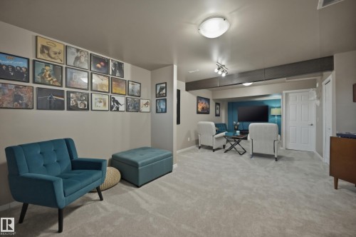 Spacious room featuring light-colored carpeting, recessed lighting, and a white paneled door - 481 Sheppard Boulevard, Leduc, AB - Indoor