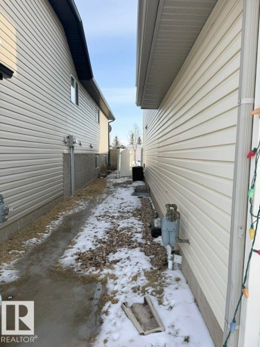 The property features light-colored horizontal siding and a dark-colored roofline - 3347 24 Avenue, Edmonton, AB - Outdoor With Exterior