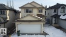 The property features a two-story exterior with light-colored siding, a garage with a white door, and a brown shingle roof - 3347 24 Avenue, Edmonton, AB  - Outdoor 