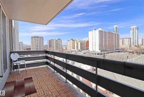 Private balcony with wood-finish tile flooring and dark gray railing - 901 10160 116 Street, Edmonton, AB - Outdoor