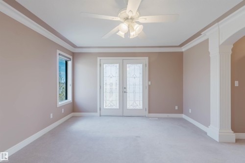 Spacious room featuring neutral carpeting, a ceiling fan with integrated lighting, and a window with a roller shade - 2408 Tegler Green, Edmonton, AB - Indoor Photo Showing Other Room