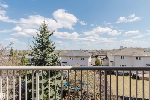 Balcony railing offering an elevated perspective of the neighborhood - 2408 Tegler Green, Edmonton, AB - Outdoor With Balcony With View