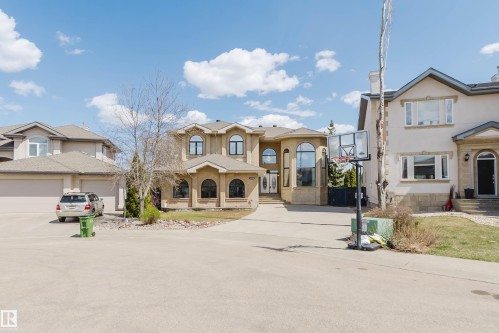 Stucco exterior featuring arched windows, multiple gables, and a prominent entry - 2408 Tegler Green, Edmonton, AB - Outdoor With Facade