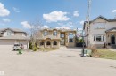 Stucco exterior featuring arched windows, multiple gables, and a prominent entry - 2408 Tegler Green, Edmonton, AB  - Outdoor With Facade 