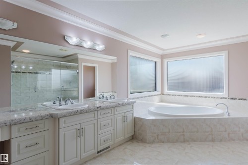 Bathroom featuring a dual vanity with undermount sinks and granite countertops - 2408 Tegler Green, Edmonton, AB - Indoor Photo Showing Bathroom